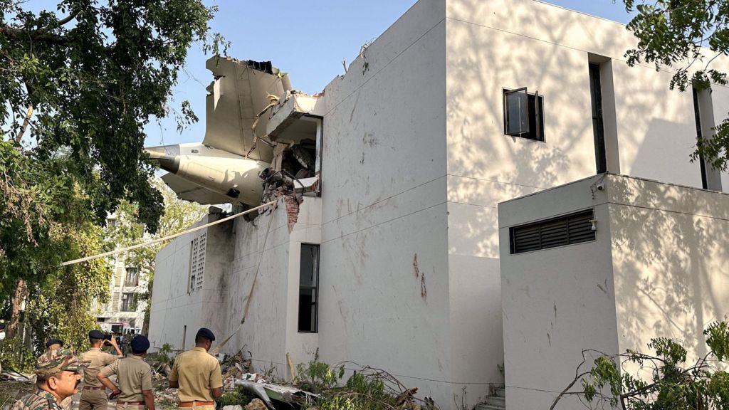 A tail of an Air India Boeing 787 Dreamliner plane that crashed is seen stuck on a building after the incident in Ahmedabad, India, June 12, 2025. REUTERS/Amit Dave