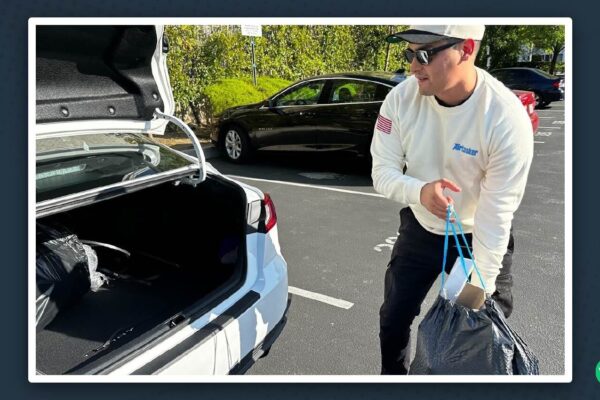 Martin De Anda loading delivery bags into the trunk of his car while wearing Airtasker gear